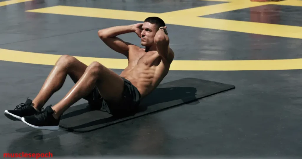 Person performing crunches on a mat with knees bent, engaging the rectus abdominis with controlled movement.