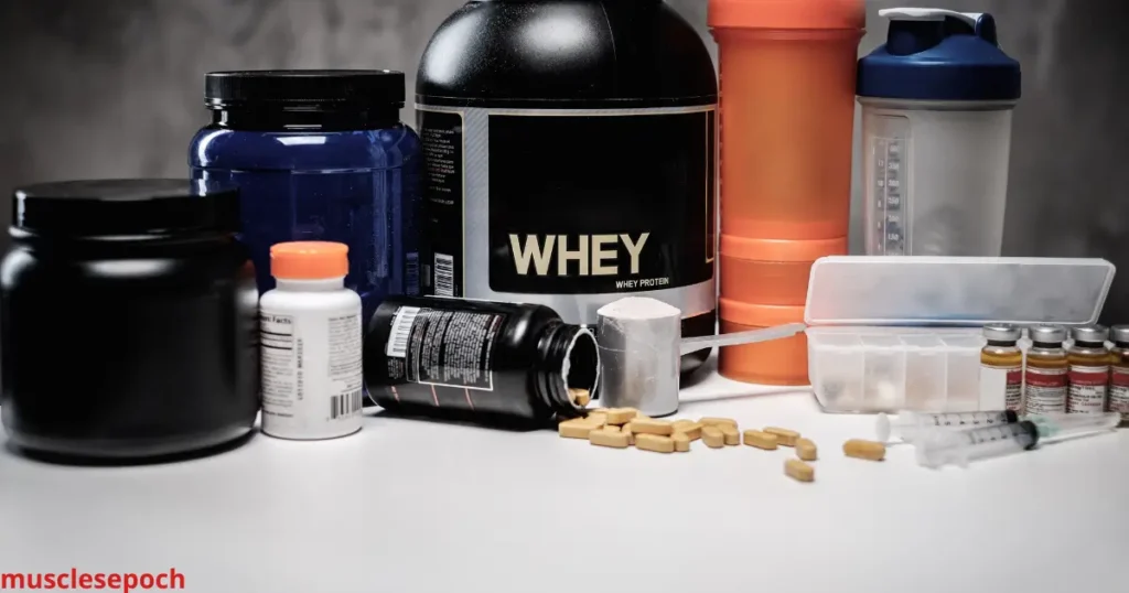 Various post-workout supplements including protein powder, BCAAs, and vitamins on a table