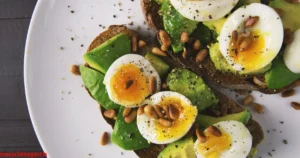 Healthy post-workout meal with protein, vegetables, and a fitness app open on a smartphone.