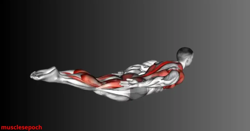 Person lying face down in a superman hold position to strengthen the lower back and improve core stability.