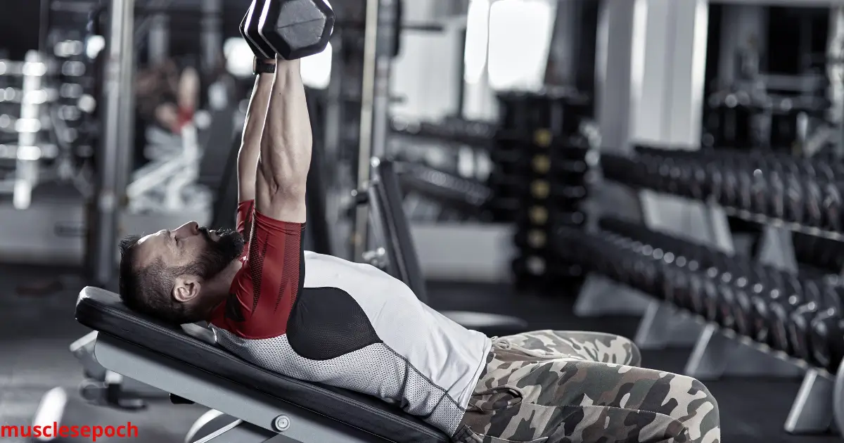 Man performing incline dumbbell press to target the upper chest muscles during a home workout.